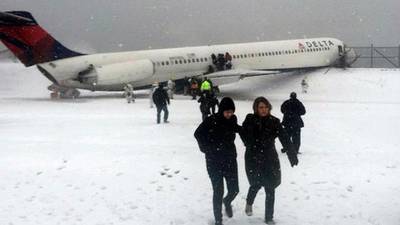 Delta plane skids off runway at snowy New York airport