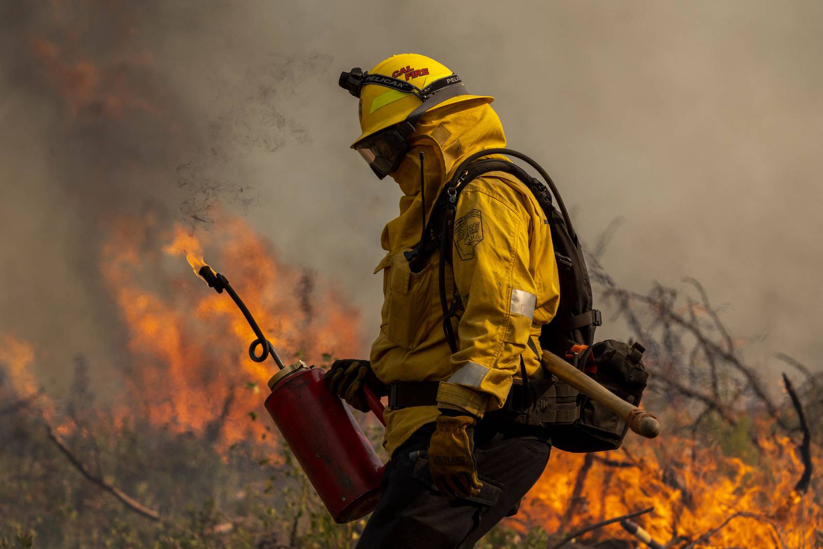 A firefighter uses a drip torch to light a backfire at the Oak Fire near Mariposa, California, on July 24th. Photograph: David McNew/AFP via Getty Images