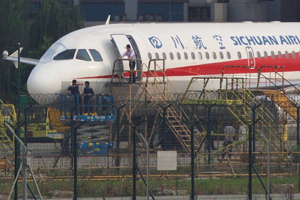 Chinese pilot partially pulled out of plane after windshield breaks