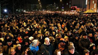 Tens of thousands of Danes hold torch-lit memorials after attacks