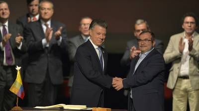 Colombia and Farc sign peace deal in sober ceremony amid opposition