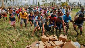 Aid choppers mobbed as typhoon relief effort spreads