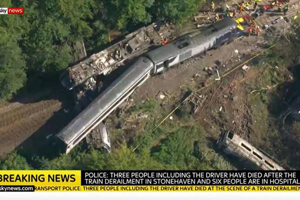 Three dead after train derails in floods-hit area of Scotland