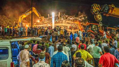 At least 100 people feared trapped after building collapses in India