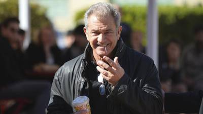 Mel Gibson denies shoving and spitting at female photographer