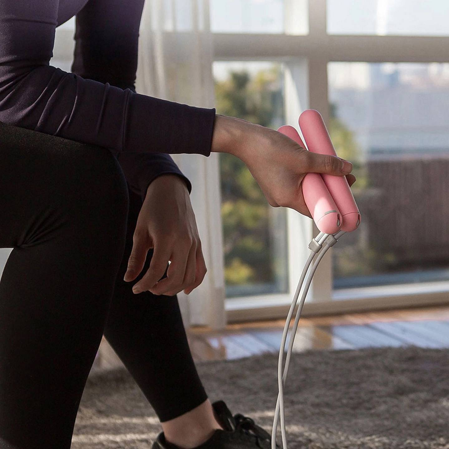 A woman holds a skipping rope