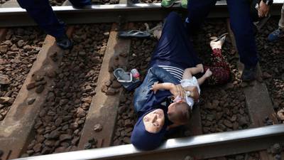Migrants dive on tracks in protest as train stops at camp