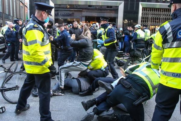 Gardaí use batons and handcuffs to quell anti-lockdown protest in Dublin