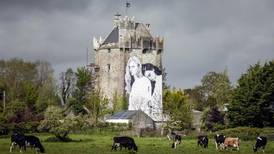 Joe Caslin installs  second mural on the side of a castle