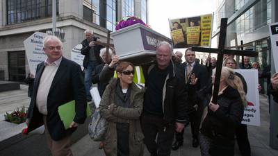 Protesters carry coffin and crosses to highlight  debt suicides
