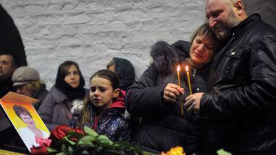Russians seek answers as burial of aircraft victims begins