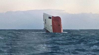 Search continues for crew of overturned cargo ship