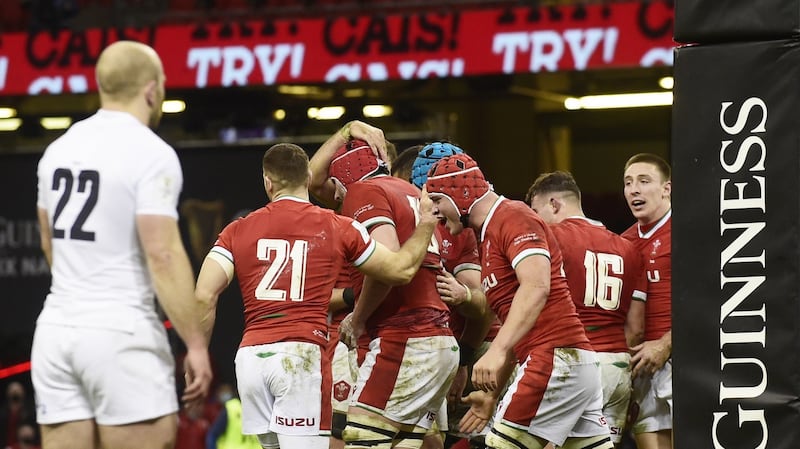 Cory Hill of Wales is  congratulated by team-mates after scoring his team’s fourth try against England in Cardiff. The way they snatched 14 points through poor refereeing and Dan Biggar’s sneakiness will only make this Triple Crown taste sweeter. Photograph: Rebecca Naden/EPA