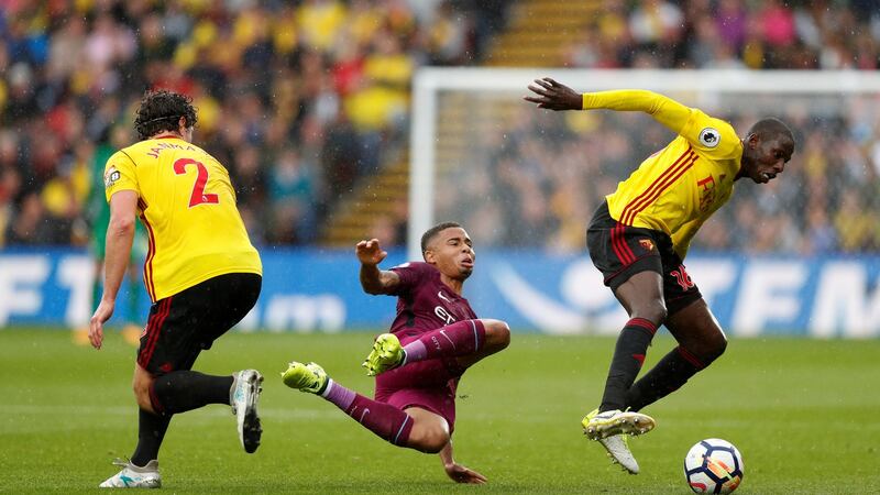 Watford’s Daryl Janmaat  and Abdoulaye Doucoure in action with Manchester City’s Gabriel at Vicarage Road. Photograph: John Sibley/Reuters