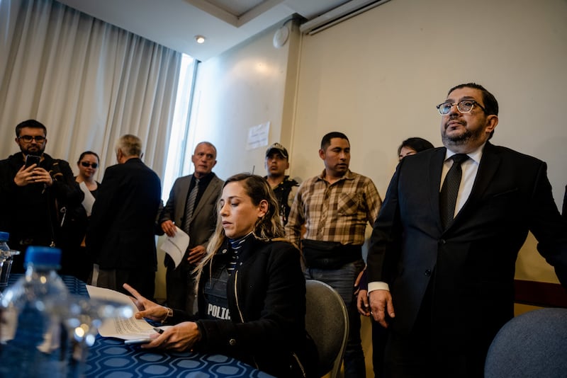 Wearing a bulletproof vest after the assassination of her running mate, the presidential candidate Fernando Villavicencio, Andrea Gonzalez speaks to reporters in Quito, Ecuador, on Thursday. Photograph: Johanna Alarcón/New York Times
                      