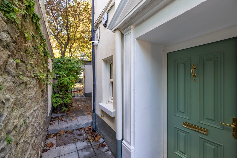 The unit has its own entrance to the side of the main door
