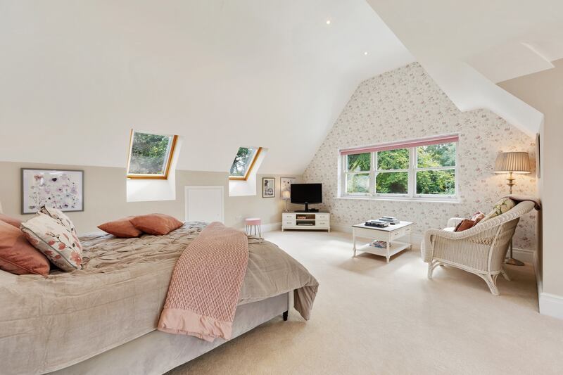 The large main bedroom has fitted wardrobes and an en suite and glazed double doors opening into the garden.