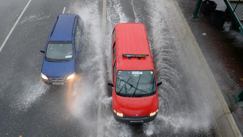 Driving in the  rain in Fairview, Dublin yesterday. Photograph: Dara Mac Dónaill