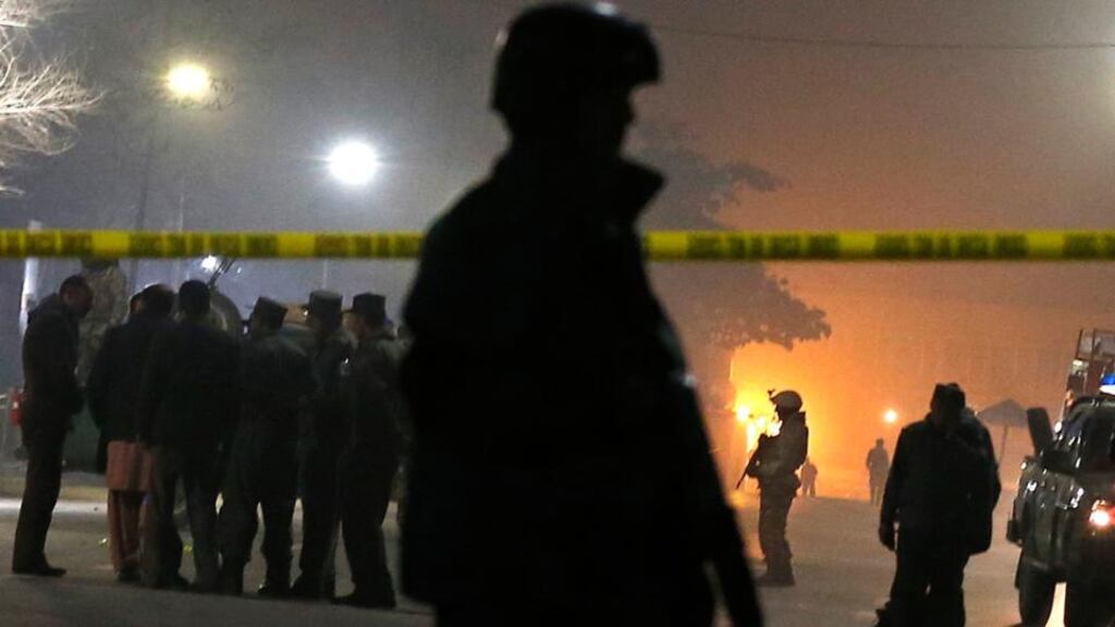 Afghan policemen stand guard at the site of a suicide bombing in Kabul. The attack targeted a French-run cultural institute and school. Photograph: Mohammad Ismail/Reuters