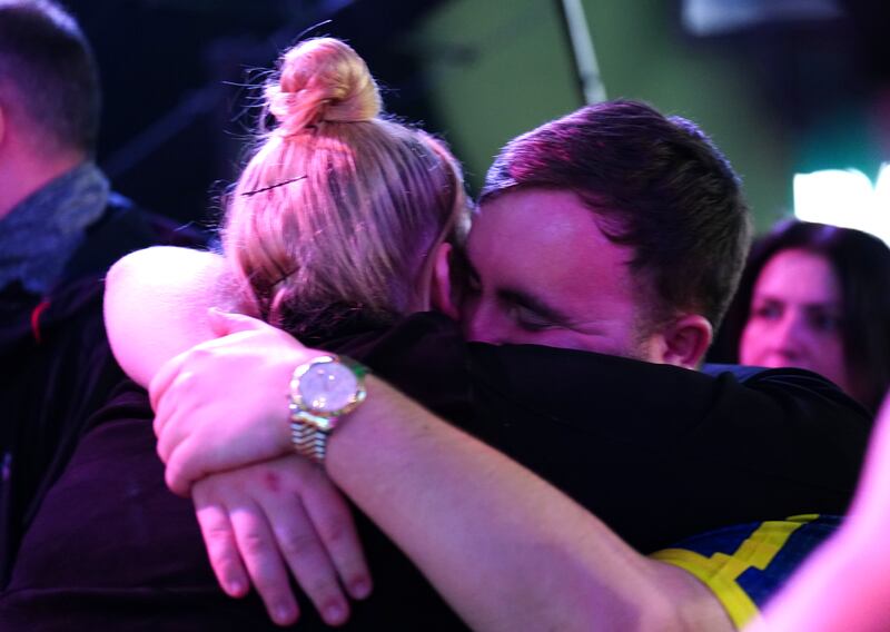 Luke Littler (right) celebrates victory in the semi-final against Rob Cross on day fifteen of the Paddy Power World Darts Championship at Alexandra Palace, London. Photograph: Zac Goodwin/PA Wire


