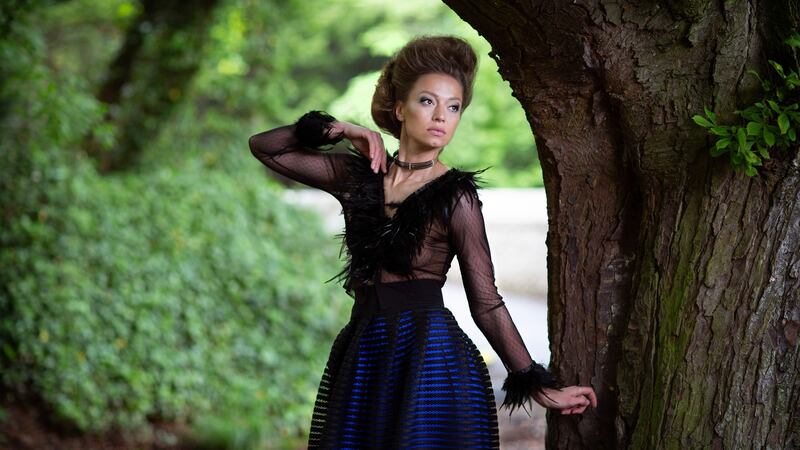 Black beaded neckpiece €145, black feather mesh top €395, black netted and electric blue silk skirt €895. Photograph: Una Williams