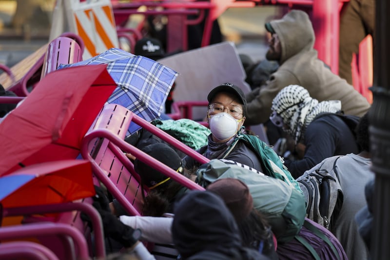 Activists hide behind a makeshift barricade during protests sparked by immigration raids in Los Angeles, California. Photograph: EPA