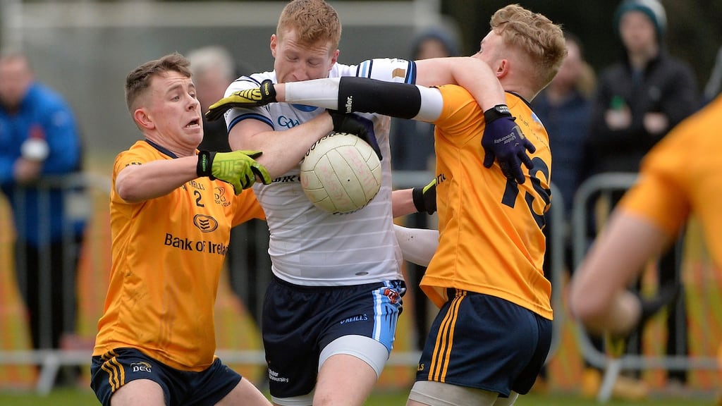 UUJ’s Kieran Hughes sees his path closed by the DCU duo of Killian Daly and Stephen Attride during the Sigerson Cup semi-final at Jordanstown. Photograph: Stephen Hamilton/Inpho/Presseye