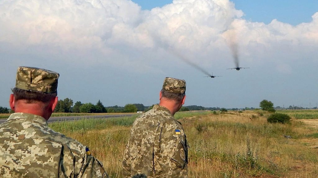 Ukrainian servicemen watch Sukhoi Su-24 front-line bombers fly during military aviation drills on Wednesday, as Russia accused Ukraine of an incursion into annexed Crimea. Photograph: Reuters/Stringer