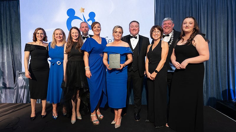 Fergus Kelly, senior project manager at Bretland, presents the health & safety excellence award - public sector to Longford County Council team