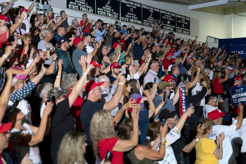 Supporters of Donald Trump cheer as he addresses them in Windham, New Hampshire, on Tuesday. Photograph: David Degner /New York Times
                      