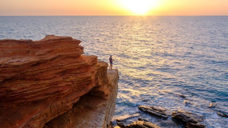 A man fishes off a cliff at Gantheaume Point,  Broome, in the Kimberley Region of Australia. Photograph: Asanka Brendon Ratnayake/The New York Times