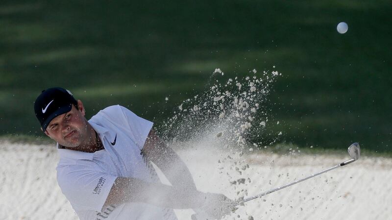 Reed hits from a bunker on the 10th hole. Photo: David J. Phillip/AP Photo