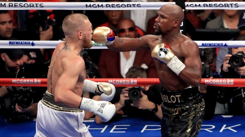 Floyd Mayweather  throws a punch at Conor McGregor during their super welterweight boxing match  at the T-Mobile Arena in Las Vegas in August 2017. Photograph: Sean M Haffey/Getty Images