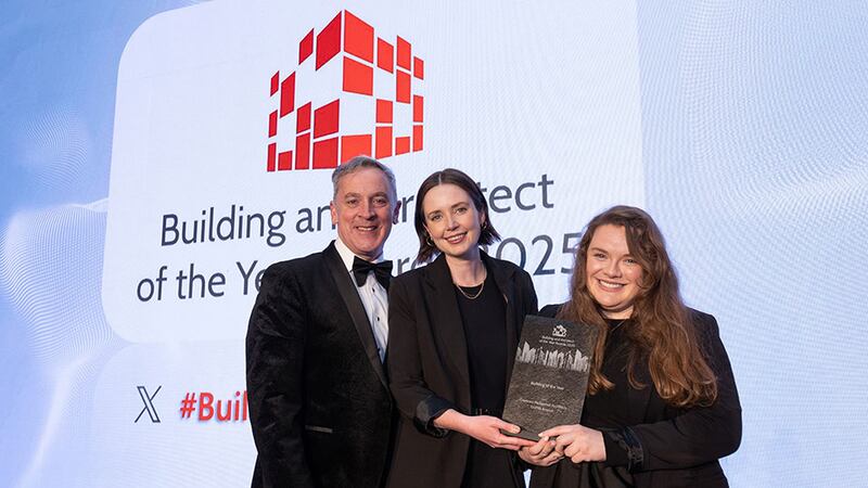 Barry Hennessy, director of business development & marketing of Walls Construction, presents building of the year award to Julie Molloy and Aoife Grogan, Courtney McDonnell Architects