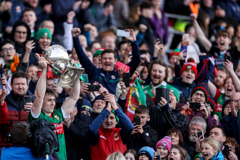 Mayo's Paddy Durcan raises the trophy to mark his county's 10th league title. Photograph: Ben Brady/Inpho