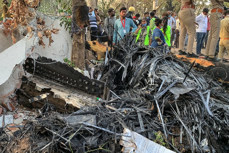 Rescue officials are seen near the wreckage of Air India flight 171 after it crashed in a residential area near the airport in Ahmedabad on June 12th, 2025. Photo by SAM PANTHAKY/AFP via Getty Images         
