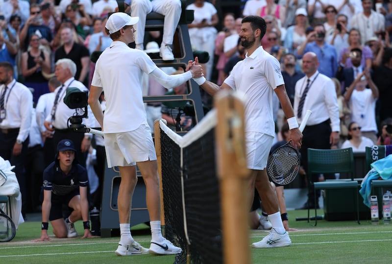 Jannik Sinner and Novak Djokovic shake hands after their semi-final on Friday. Photograph: Clive Brunskill/Getty Images