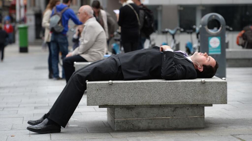 A man suns himself during his lunch break on Dame Street in Dublin earlier this week. Photograph: Dara Mac Dónaill / The Irish Times
