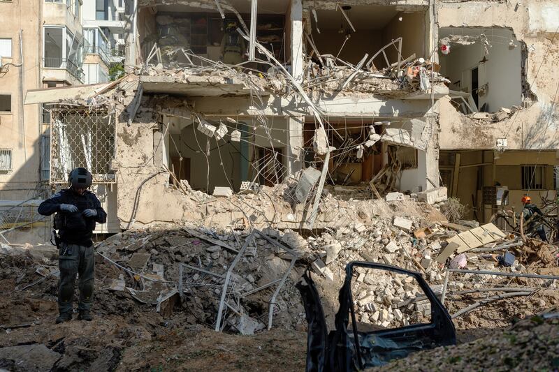 Emergency services attend the impact site of an Iranian missile on Tuesday in Tel Aviv, Israel. Photograph: Erik Marmor/Getty Images