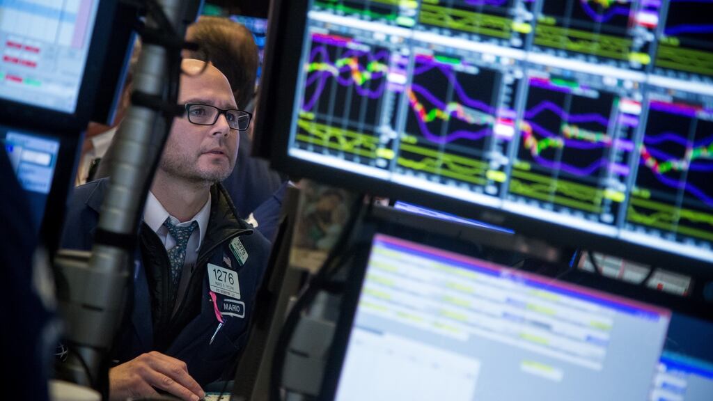 A trader works on the floor of the New York Stock Exchange on Friday. Stocks climbed after new figures showed the US economy had grown 3 per cent in the third quarter. Photograph: Michael Nagle/Bloomberg