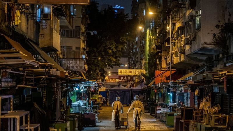 Health authorities in personal protective equipment in Jordan, a working-class neighbourhood in Hong Kong where there was a coronavirus outbreak. Photograph: Lam Yik Fei/The New York Times