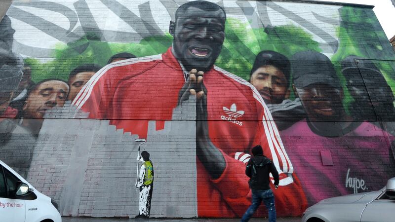 On Subset’s Stormzy piece in Smithfield, Dublin, there is a stencil of a council worker “painting” over a section of the piece. Photograph: Dara Mac Donaill