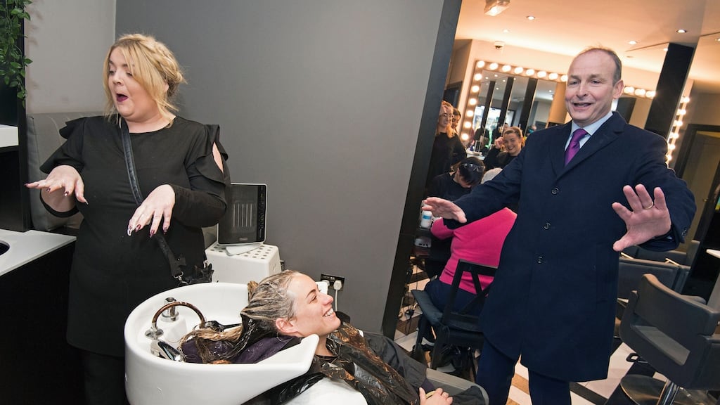 Fianna Fáil leader Micheál Martin canvassing for the upcoming general election in Cabra and Phibsborough, meeting hairdresser Erica Oragano and her client Dezirae Stephan. Photograph: Dave Meehan