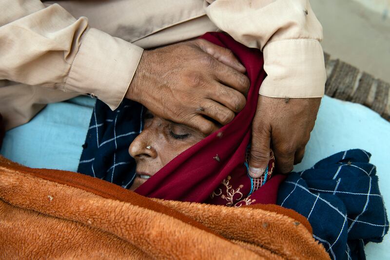 Jafar cares for his wife, who has been sick with malaria, in the village of Wado Khosa, Pakistan. Photograph: Kiana Hayeri/The New York Times