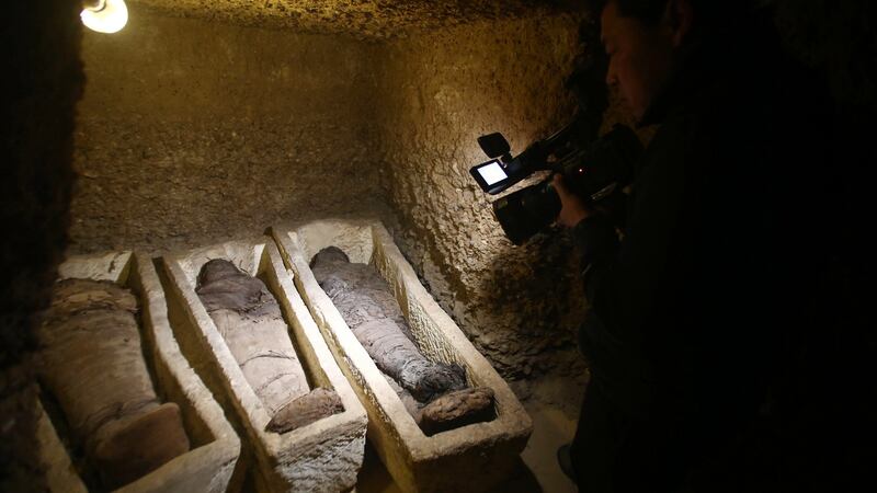 A videographer films  mummies found at Tuna el-Gebel archaeological site in Minya, 270km south of Cairo on Saturday. Photograph: EPA