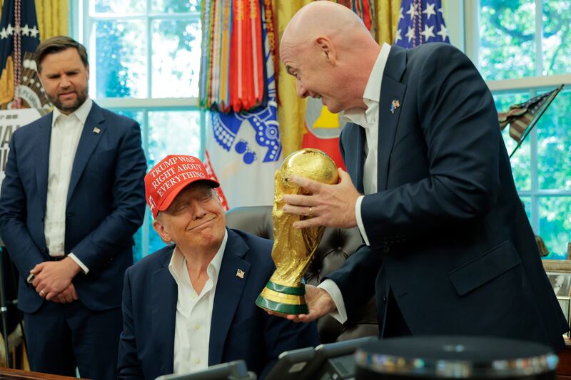 World Cup: Fifa president Gianni Infantino shows Donald Trump the trophy in the Oval Office in August 2025. Photograph: Chip Somodevilla/Getty
