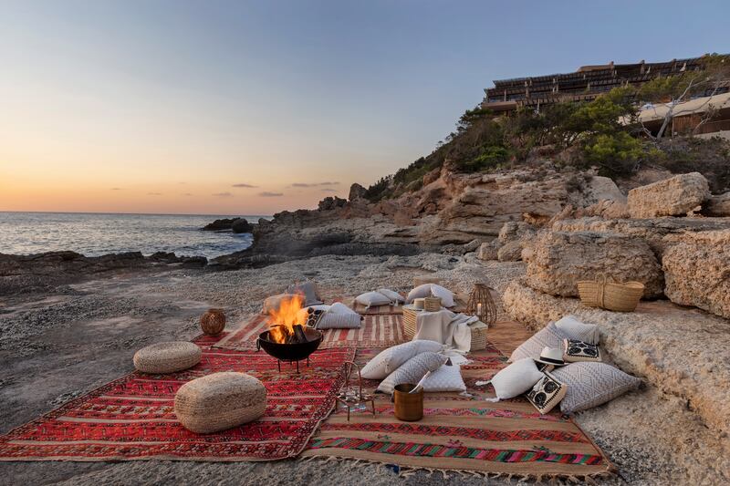 A secluded cove in Ibiza, where beach picnics, clear water and slower afternoons capture a quieter side of the Balearics