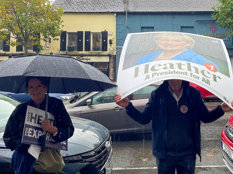 Supporters of Heather Humphreys shelter from the rain as she canvasses in Gorey, Co Wexford, on Monday. Photograph: Gráinne Ní Aodha/PA Wire