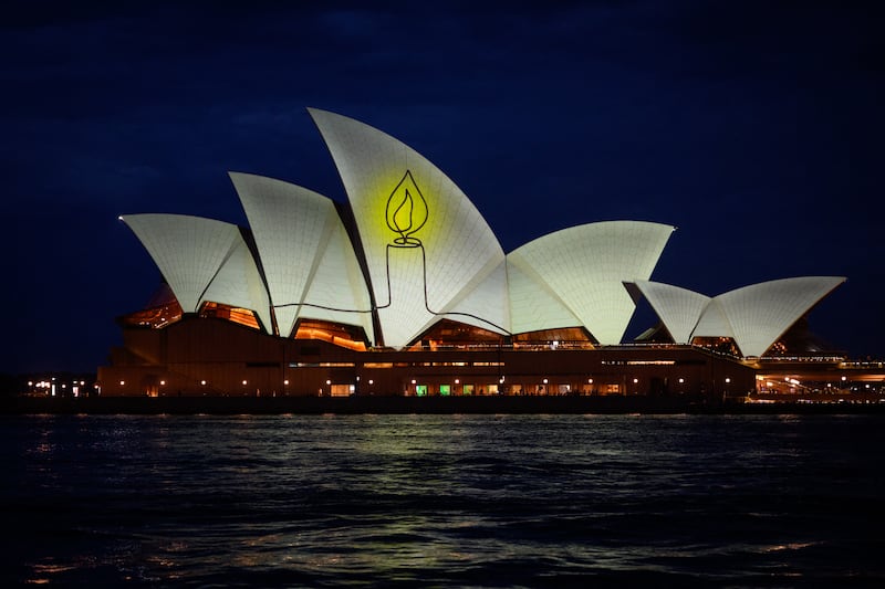 The Sydney Opera House is illuminated with candlelights in Sydney on December 21st as part of a national day of reflection honouring the victims of the Bondi Beach terrorist attack. Photograph: George Chan/ AFP via Getty Images