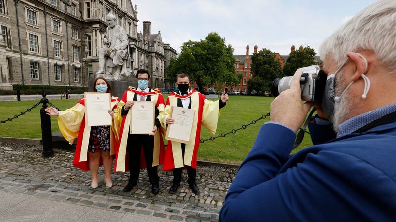 Emer Browne, James McKeown and Jeremiah Kelleher celebrate after graduating. Photograph: Alan Betson